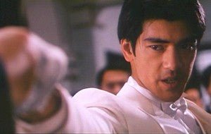 Scene from Hero (Blu Ray) featuring Takeshi Kaneshiro in a dynamic pose, showcasing intense action and drama.