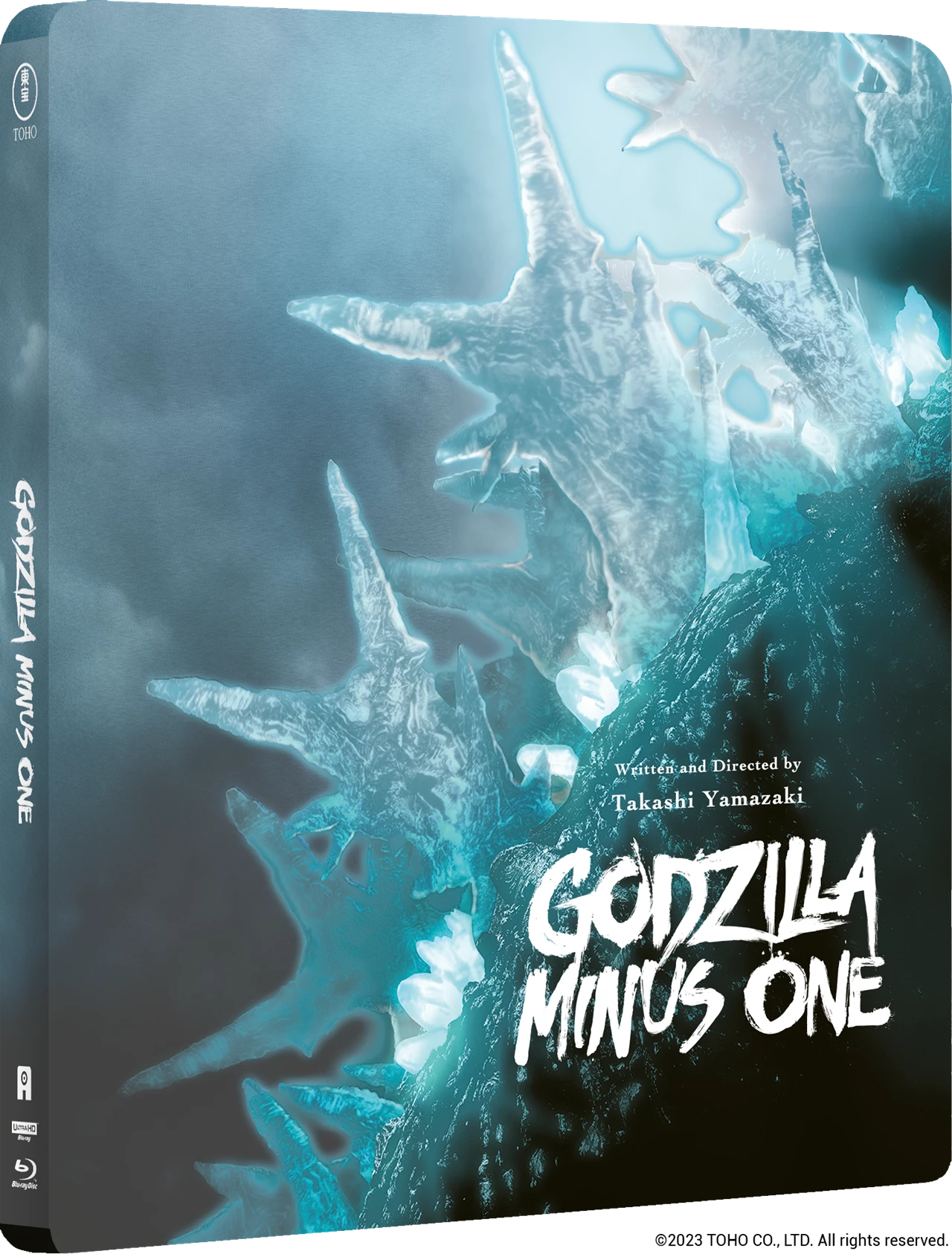 Godzilla Minus One steelbook case cover art, showing icy blue spire-like structures against a dark smoky background with the title in large white text. The spine is visible on the left, and small TOHO branding appears at the bottom.